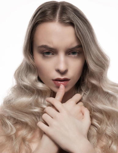 Beautiful Caucasian woman with blond hair and pained expression