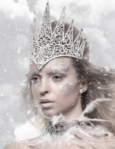 Beautiful Caucasian girl wearing crown with white make up in a snow storm
