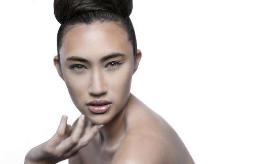 beautiful asian woman with green eyes and  hair in a bun